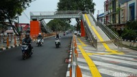 Uniknya jalur naik atau turun di JPO itu bukan berupa tangga. Jalur itu dibuat landai dengan guiding block di bagian tengahnya. 