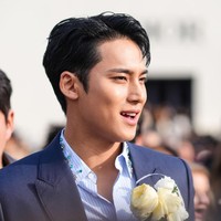 Kemeja Dior yang dipakai Mingyu Seventeen ini memiliki detail hiasan batu permata dan zamrud biru yang senada dengan blazer dan celananya. Foto: Getty Images/Edward Berthelot