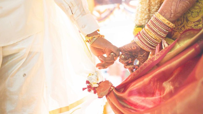 hindu wedding bride and groom celebrating wedding event with flower decorations