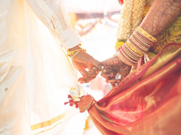 hindu wedding bride and groom celebrating wedding event with flower decorations