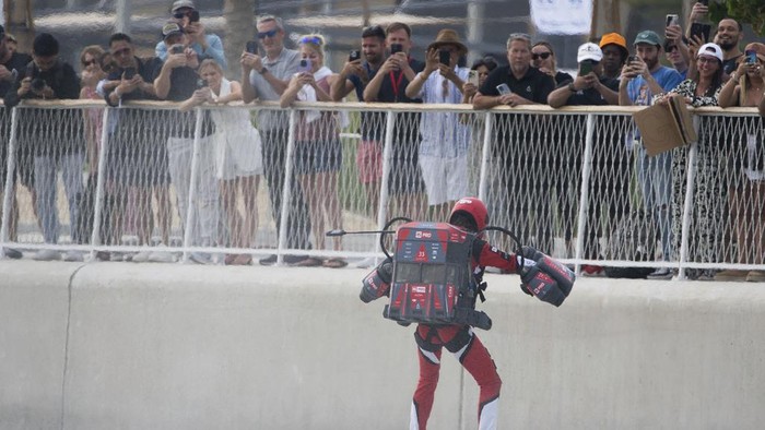 Jet suit pilots race in Dubai, United Arab Emirates, Wednesday, Feb. 28, 2024. Dubai on Wednesday hosted what it called its first-ever jet suit race. Racers zipped along a route with the skyscrapers of Dubai Marina looming behind them, controlling the jet engines on their hands and their backs. (AP Photo/Jon Gambrell)
