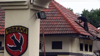 Seorang pekerja sedang membenahi genteng salah satu kantor yang rusak usai ledakan di Mako Brimob.