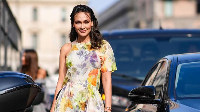 MILAN, ITALY - FEBRUARY 21: Luna Maya wears a colored floral print gathered mini dress, white boots, outside Onitsuka Tiger , during the Milan Fashion Week - Womenswear Fall/Winter 2024-2025 on February 21, 2024 in Milan, Italy. (Photo by Edward Berthelot/Getty Images)
