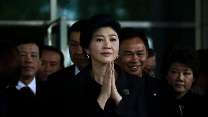 Ousted former Thai prime minister Yingluck Shinawatra greets supporters as she arrives at the Supreme Court in Bangkok, Thailand, July 21, 2017. REUTERS/Athit Perawongmetha/File Photo Purchase Licensing Rights