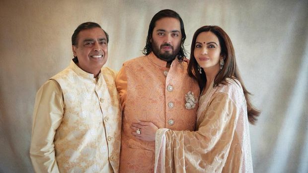 This photograph released by the Reliance group shows from L to R, billionaire industrialist Mukesh Ambani, son Anant and wife Nita, posing for a photograph as guests gather to celebrate Anant's wedding in Jamnagar, India, Saturday, Mar. 02, 2024. (Reliance group via AP)
