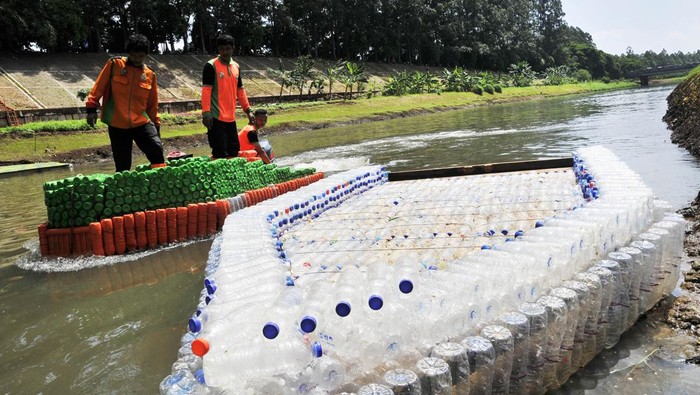 Perahu berbahan sampah botol plastik Sejumlah petugas Unit Penanganan Sampah Badan Air Dinas Lingkungan Hidup mengangkat perahu berbahan botol plastik bekas di Duren Sawit, Jakarta Timur, Selasa (5/3/2024). Menurut petugas UPS Badan Air sebanyak 1.000 botol plastik dimanfaatkan untuk pembuatan perahu selama dua minggu yang bisa membawa enam orang saat melakukan pembersihan sampah di aliran Kanal Banjir Timur. ANTARA FOTO/ Fakhri Hermansyah/aww.