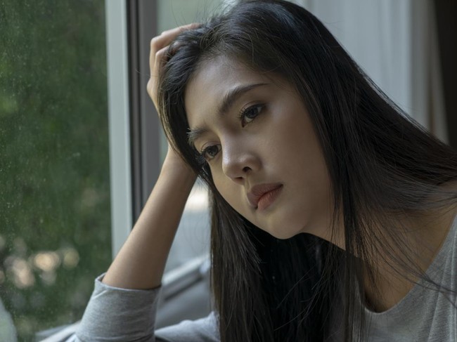 Young Asian woman feeling sad tired and worried suffering depression in mental health, problems and broken heart concept.