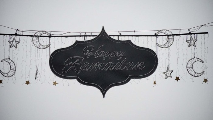 A camera team films Ramadan lights which have been installed at the Grosse Bockenheimer Strasse, called 