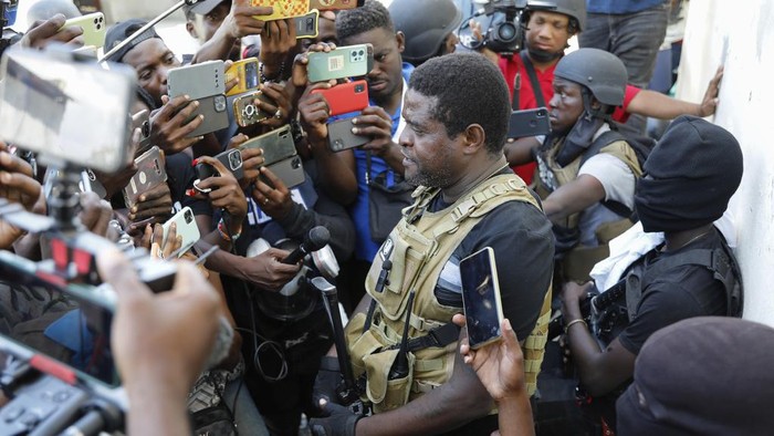 Barbecue, the leader of the G9 and Family gang, speaks to journalists in the Delmas 6 neighborhood of Port-au-Prince in Port-au-Prince, Haiti, Tuesday, March 5, 2024. Haitis latest violence began with a direct challenge from Barbecue, a former elite police officer, who said he would target government ministers to prevent the prime ministers return and force his resignation. (AP Photo/Odelyn Joseph)