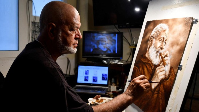 Artist Milton Bernal poses for a photo while working in his studio in Havana, Cuba, February 24, 2024. REUTERS/Norlys Perez