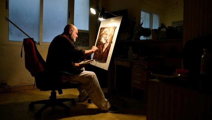 Artist Milton Bernal poses for a photo while working in his studio in Havana, Cuba, February 24, 2024. REUTERS/Norlys Perez