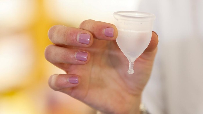 A pharmacist shows to a customer the reusable menstrual underwear which is distributed, along with other reusable menstrual products including menstrual cups and reusable pads, free of charge in Catalonia region, at a chemist in Barcelona, Spain, March 4, 2024. REUTERS/Albert Gea