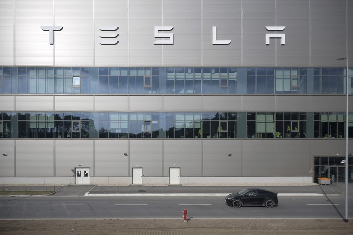 A general view of the Tesla Gigafactory for electric cars in Gruenheide near Berlin, Germany, Tuesday, March 5, 2024. Production at Teslas electric vehicle plant in Germany came to a standstill and workers were evacuated after a power outage that officials suspect was caused by arson. The interior ministry in the state of Brandenburg says unidentified people are suspected of deliberately setting fire to a high-voltage transmission line on a power pylon. (AP Photo/Ebrahim Noroozi)