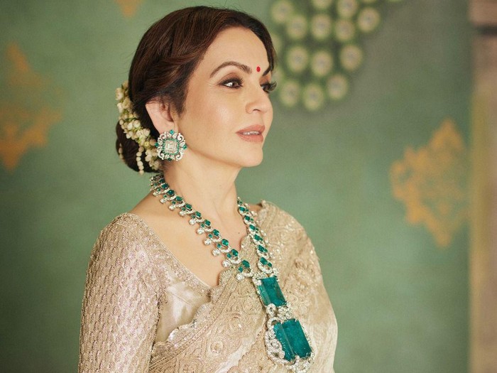 In this photograph released by the Reliance group, Nita Ambani, wife of billionaire industrialist Mukesh Ambani poses wearing a Kanchipuram sari, handcrafted by weavers from South India, at a pre-wedding bash of their son Anant Ambani in Jamnagar, India, Sunday, March 3, 2024. (Reliance group via AP)