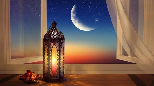 Ramadan lantern by the open window. Beautiful Greeting Card with copy space for Ramadan and Muslim Holidays. An illuminated Arabic lamp. Mixed media.