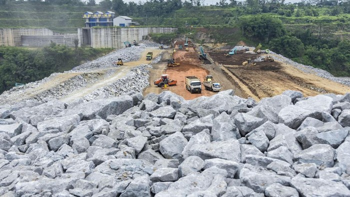 Begini Progres Terbaru Proyek Bendungan Leuwikeris Foto udara pekerja menggunakan alat berat mengangkut material batu andesit untuk pembangunan Bendungan Leuwikeris di Gunung Pangajar, Kabupaten Tasikmalaya, Jawa Barat, Kamis (7/3/2024). Kementerian PUPR terus mendorong optimalisasi pemanfaatan waduk atau bendungan multiguna untuk mencapai target Energi Baru Terbarukan (EBT) sebesar 23 persen pada tahun 2025 menuju zero emission pada tahun 2060. ANTARA FOTO/Adeng Bustomi/YU