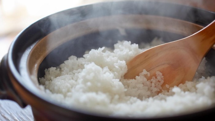 Hot cooked rice with steam rising.