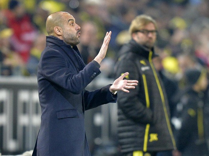 Bayern head coach Pep Guardiola of Spain, left, reacts to his team beside Dortmund head coach Juergen Klopp, right, during the German Bundesliga soccer match between Borussia Dortmund and Bayern Munich in Dortmund, Germany, Saturday, Nov. 23, 2013.  (AP Photo/Martin Meissner)