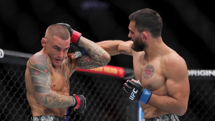 Mar 9, 2024; Miami, Florida, USA; Benoit Saint Denis (blue gloves) fights Dustin Poirier (red gloves) during UFC 299 at Kayesa Center. Mandatory Credit: Sam Navarro-USA TODAY Sports
