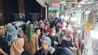 Pengunjung membawa kantong belanjaan hingga ada juga yang membawa plastik besar di pundak. Saking padatnya, sejumlah pengunjung memilih mengemper di pinggir jalan.
