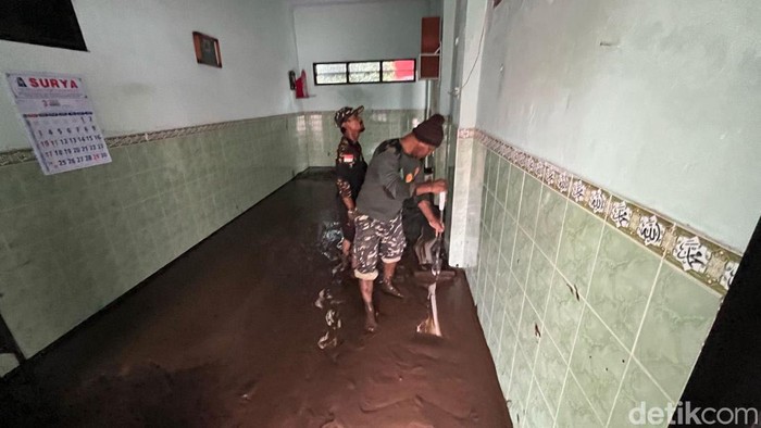 Warga bersihkan lumpur usai banjir di mojokerto surut Warga bersihkan lumpur usai banjir di mojokerto surut