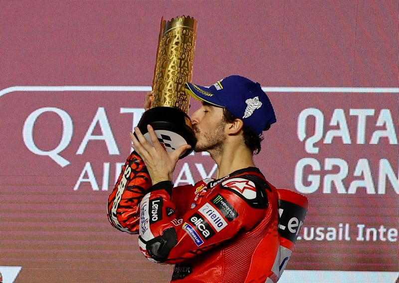 MotoGP - Grand Prix of Qatar - Lusail International Circuit, Lusail, Qatar - March 10, 2024 Ducati Lenovo Team's Francesco Bagnaia celebrates on the podium with the trophy after winning the MotoGP REUTERS/Ibraheem Al Omari