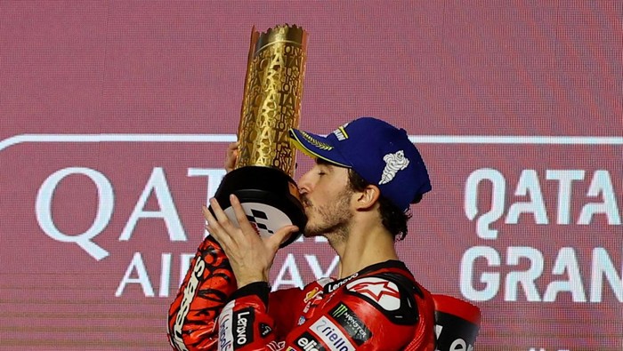 MotoGP - Grand Prix of Qatar - Lusail International Circuit, Lusail, Qatar - March 10, 2024 Ducati Lenovo Teams Francesco Bagnaia celebrates on the podium with the trophy after winning the MotoGP REUTERS/Ibraheem Al Omari