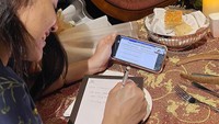 Sambil makan malam, rupanya Erina juga sambil berkegiatan. Ia tampak sibuk dengan zoom meetingnya, sambil ditemani dengan kue manis. Foto: Instagram @Erinagudono