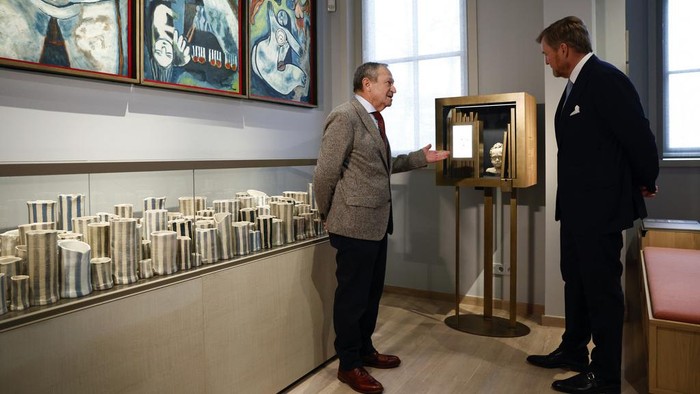 Netherlands' King Willem Alexander, right, tours the National Holocaust Museum in Amsterdam, Netherlands,  Sunday, March 10, 2024. The Netherlands National Holocaust Museum is opening on Sunday in a ceremony presided over by the Dutch king as well as Israeli President Isaac Herzog, whose presence is prompting protest because of Israel's deadly offensive against Palestinians in Gaza. (Piroschka van de Wouw/Pool Photo via AP)