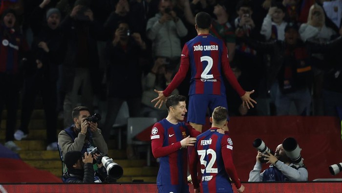 Barcelonas Joao Cancelo celebrates after scoring his sides second goal during the Champions League, round of 16, second leg soccer match between FC Barcelona and SSC Napoli at the Olympic Stadium in Barcelona, Spain, Tuesday, March 12, 2024. (AP Photo/Joan Monfort)
