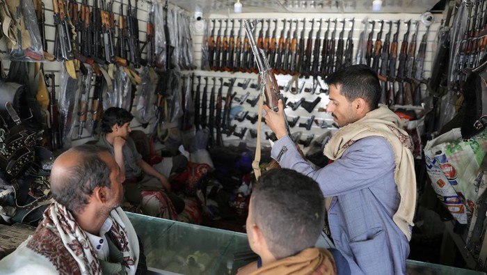 An arms dealer inspects a rifle at his shop, as the war in Gaza and the U.S.-led strikes on Houthi targets raise demand for firearms, in Sanaa, Yemen March 6, 2024. REUTERS/Khaled Abdullah