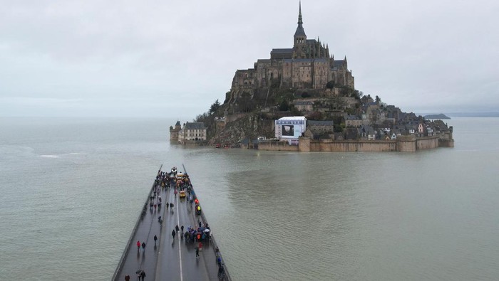 A drone view shows Mont Saint-Michel surrounded by sea during a high tide, in the French western region of Normandy, France, March 12, 2024. REUTERS/Stephane Mahe     TPX IMAGES OF THE DAY