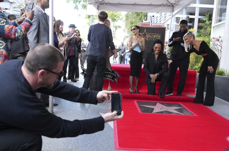 Zoe Kravitz, right, speaks at a ceremony honoring Lenny Kravitz, left, with a star on the Hollywood Walk of Fame on Tuesday, March 12, 2024, in Los Angeles. (Photo by Jordan Strauss/Invision/AP)