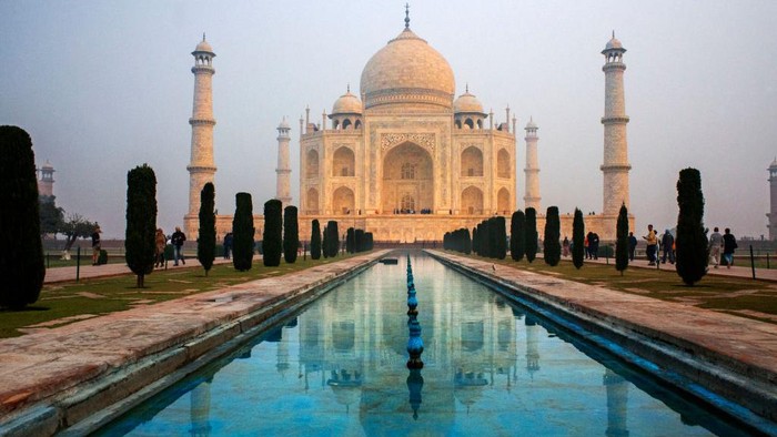 Taj Mahal tomb with reflection in the water at blue dramatic sky in Agra, Uttar Pradesh, India. This is one of the excursion of the Luxury train Maharajas express. (Photo by: Sergi Reboredo/VW Pics/Universal Images Group via Getty Images)