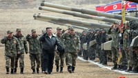 Dalam foto yang dirilis KCNA, Kim tampak memeriksa deretan tank yang ada di acara tersebut.  