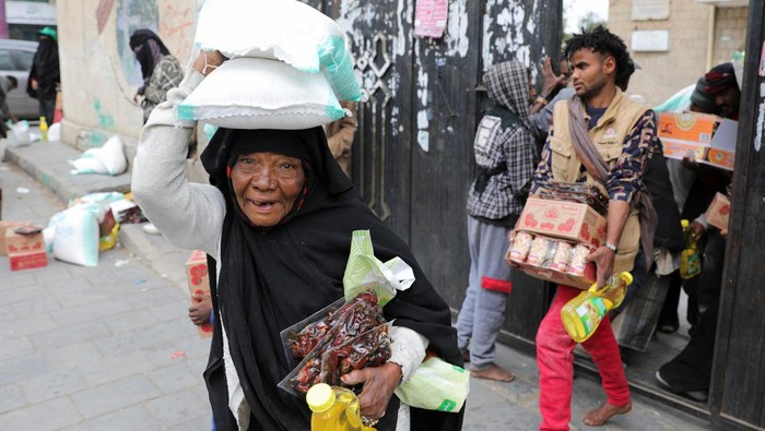 People carry foodstuff distributed by the Mona Relief Yemen charity during the fasting month of Ramadan, amid a high level of food insecurity, in Sanaa, Yemen March 14, 2024. REUTERS/Khaled Abdullah