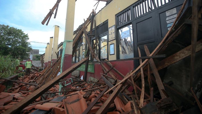 Dua pelajar melihat atap ruang kelas sekolah yang ambruk di Sekolah Dasar Negeri (SDN) Kedaung, Sawangan, Depok, Jawa Barat, Sabtu (16/3/2024). Ambruknya atap ruang kelas tersebut akibat diguyur hujan deras pada, Jumat (15/3/2024), tidak ada korban jiwa dalam peristiwa tersebut. ANTARA FOTO/Muhammad Iqbal/wpa.