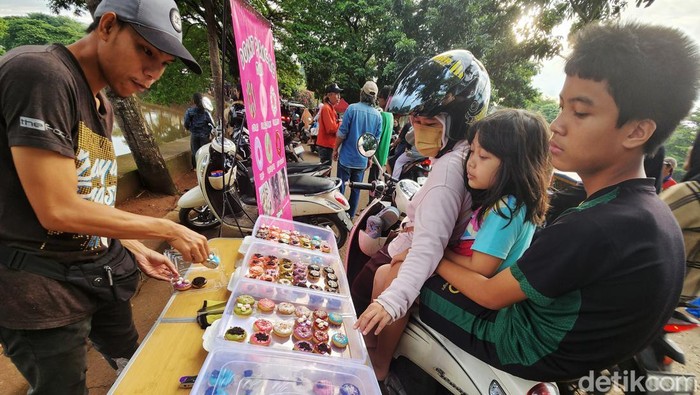 Sejumlah warga berburu takjil sembari menunggu waktu berbuka puasa (ngabuburit) di Jl Inspeksi Pesanggrahan, Jakarta Selatan, Minggu (17/3/2024). Berbagai jajanan dan foodstreet hingga baju serta wahana permainan ditawarkan di pasar tiban ini. Keramaian ini terlihat saat Ramadan terutama menjelang berbuka puasa.