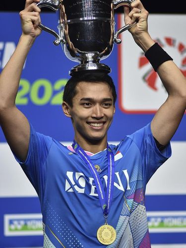 Indonesia's Jonatan Christie poses with the trophy after winning the men's singles final match of the All England Open Badminton Championships against Indonesia's Anthony Sinisuka Ginting at the Utilita Arena in Birmingham, England, Sunday, March 17, 2024. (AP Photo/Rui Vieira)