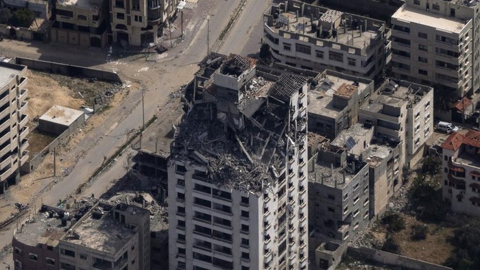 Destroyed buildings are seen through the window of an airplane from the U.S. Air Force, as they stand in the Gaza Strip, Thursday, March 14, 2024. (AP Photo/Leo Correa)