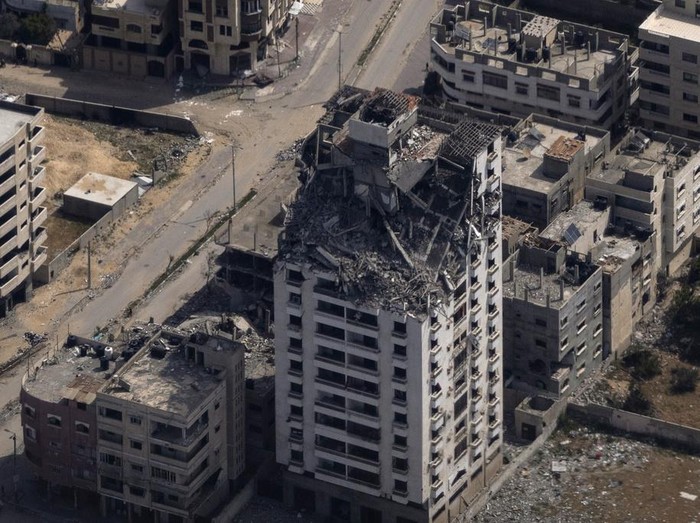 Destroyed buildings are seen through the window of an airplane from the U.S. Air Force, as they stand in the Gaza Strip, Thursday, March 14, 2024. (AP Photo/Leo Correa)