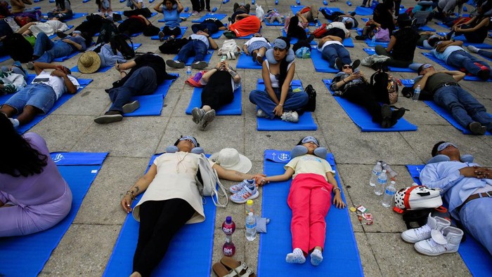 People participate in a massive nap to mark World Sleep Day, at the Monument to the Revolution in Mexico City, Mexico March 15, 2024. REUTERS/Raquel Cunha
