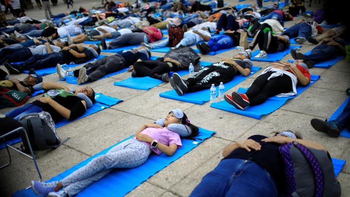 People participate in a massive nap to mark World Sleep Day, at the Monument to the Revolution in Mexico City, Mexico March 15, 2024. REUTERS/Raquel Cunha