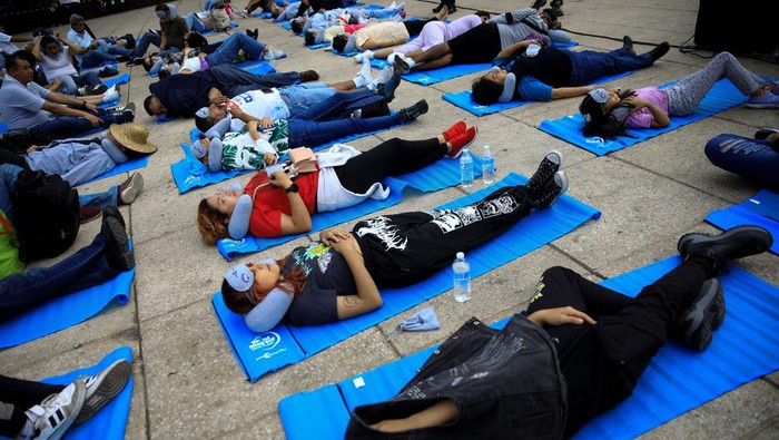 People participate in a massive nap to mark World Sleep Day, at the Monument to the Revolution in Mexico City, Mexico March 15, 2024. REUTERS/Raquel Cunha