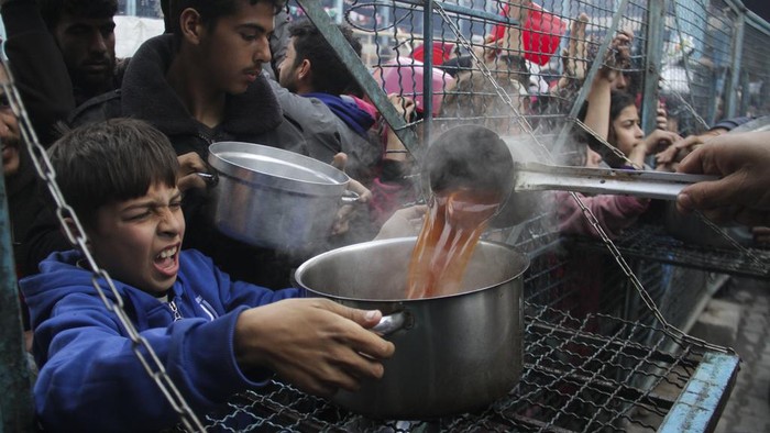 Palestinians line up to receive free meals at Jabaliya refugee camp in the Gaza Strip on Monday, March 18, 2024. (AP Photo/Mahmoud Essa)