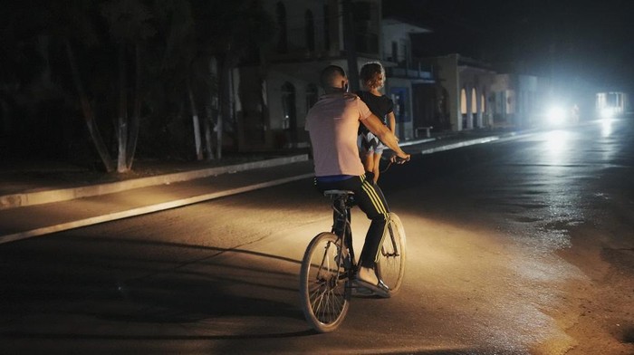 People walk during a scheduled power outage in Bauta, Cuba, Monday, March 18, 2024 The country is facing an energy crisis, with waves of blackouts worsening in recent weeks. (AP Photo/Ramon Espinosa)