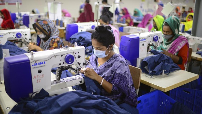 FILE - Garment employees work at Arrival Fashion Limited in Gazipur, Bangladesh, Saturday, March 13, 2021. The European Union warned consumers to stop using their clothes like throwaway items and said Wednesday, March 30, 2022, that it plans to count