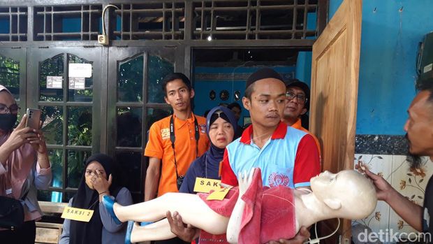 Tersangka Muhammad Rosyid memperagakan saat menganiaya anak tirinya dalam reka ulang yang digelar di rumahnya, Selasa.(19/3/2024)