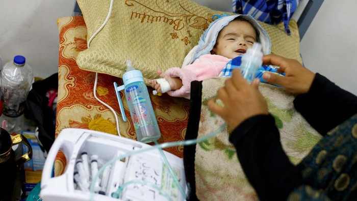 Palestinian woman Wafaa Tabasi holds her twin malnourished daughter Sameera, At al-Awda health centre in Rafah in the southern Gaza Strip, March 12, 2024. REUTERS/Mohammed Salem     TPX IMAGES OF THE DAY