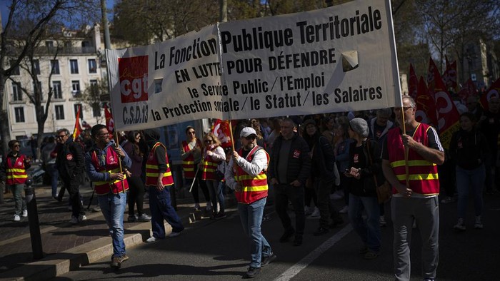 Public sector workers march during a demonstration in Marseille, southern France, Tuesday, March 19, 2024. (AP Photo/Daniel Cole)